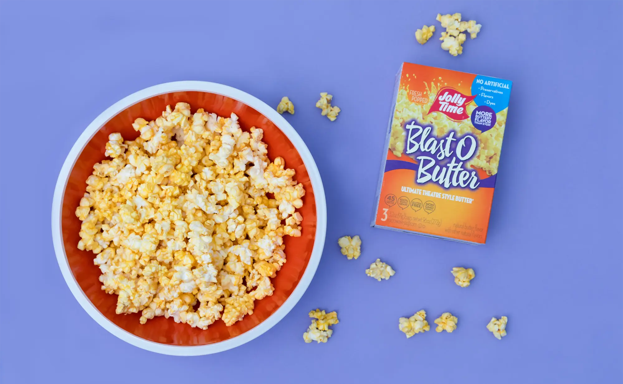 Blast O Butter microwave popcorn box sitting next to a bowl of Blast O Butter popcorn. You can't go wrong with Blast O Butter as a movie night treat!