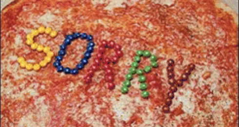 Short animated gif showing Michaeal from the Princess Diaries opening a box of pizza with the word SORRY spelled out in M&Ms. Make your movie night memorable with a theme of the Princess Diaries!